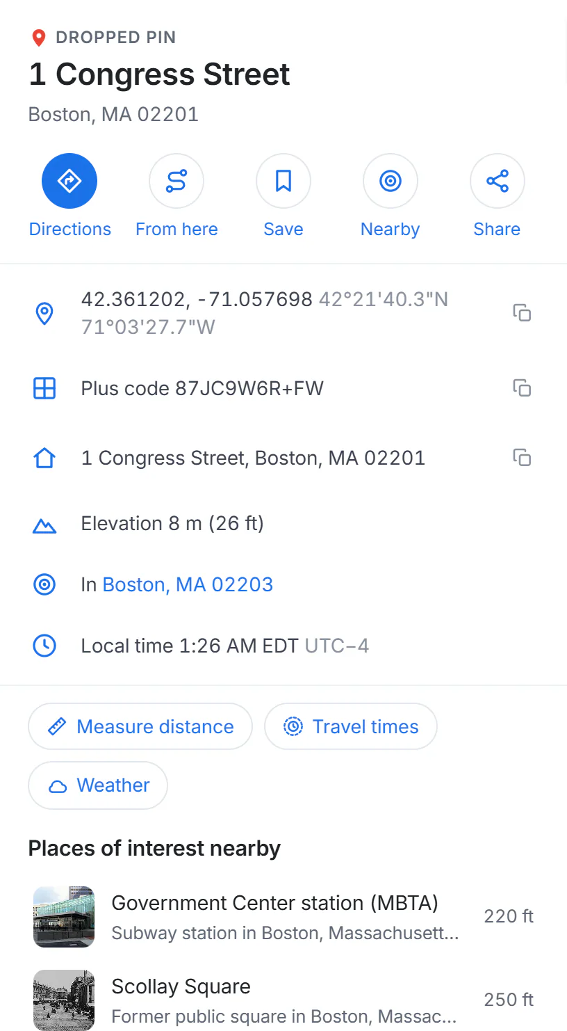 The panel for a dropped pin: the street address, buttons for Directions, From here, Save, Nearby and Share, then coordinates, a plus code, the address, elevation, the nearest town and local time, and buttons for Measure distance and Travel times